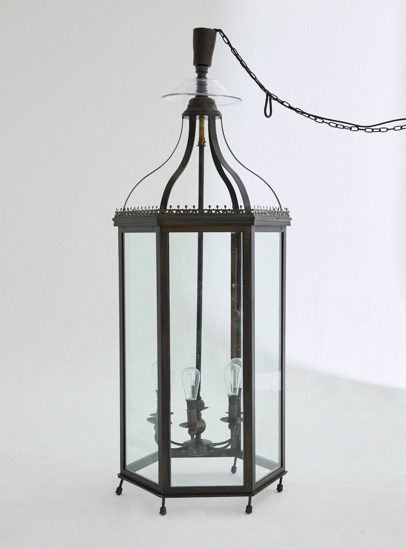 An oversized traditional lantern light fitting that can be suspended or stood