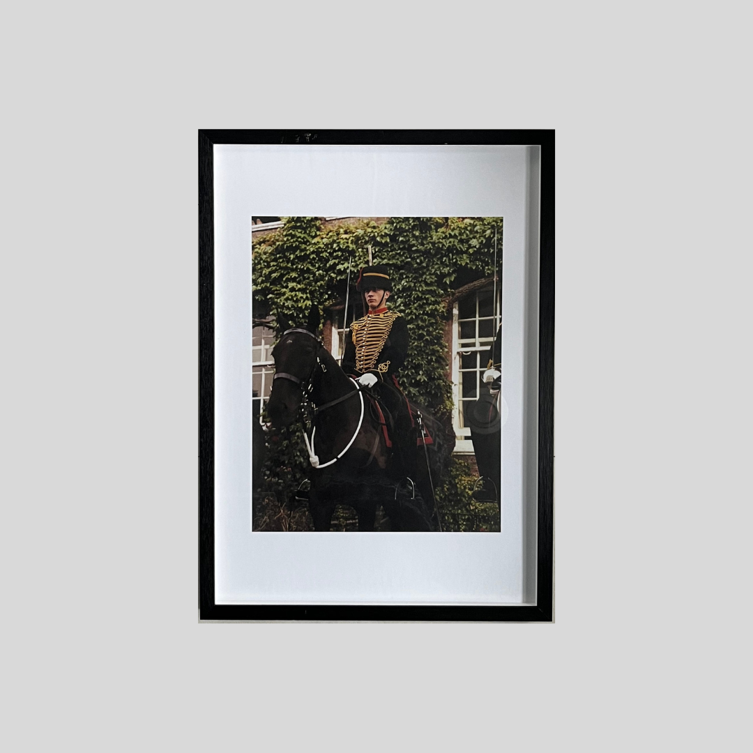 Medium framed colour photographic print of dress uniformed soldier on horse back