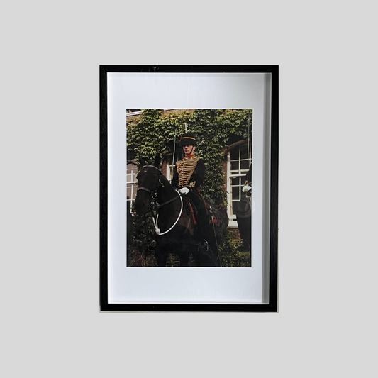Medium framed colour photographic print of dress uniformed soldier on horse back