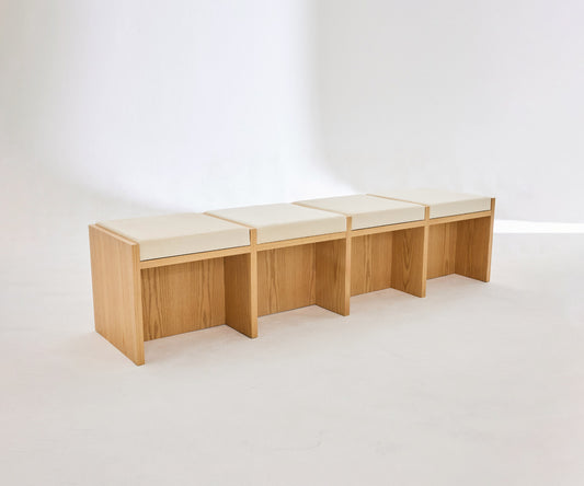 Four seater wooden bench made from beech with soft beige velvet cushions