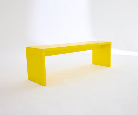 A bright yellow long bench 